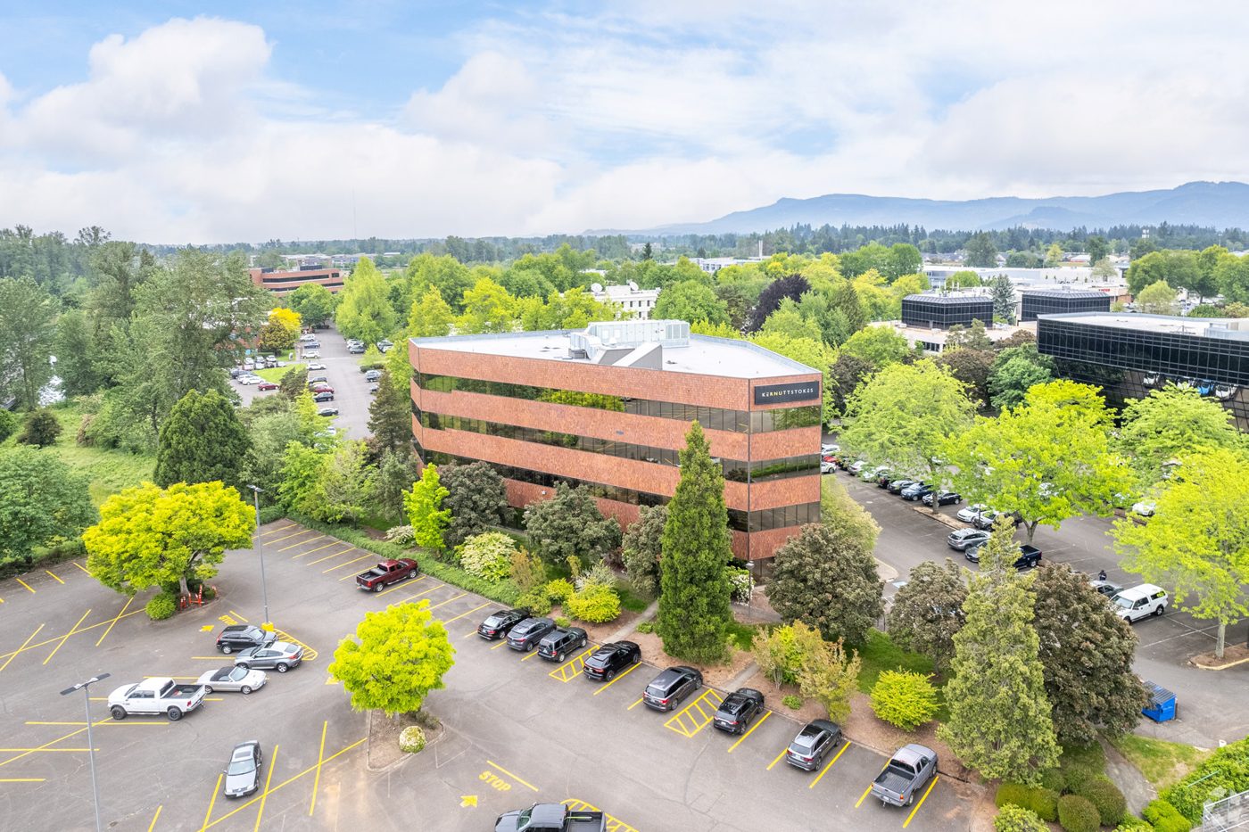 Aerial view of the 1600 Executive Parkway building among the trees near Valley River Center, Eugene